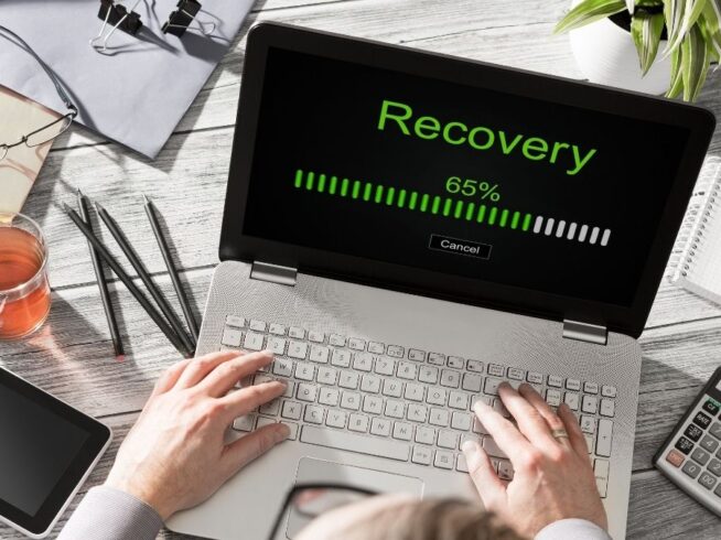 hands using a laptop in disaster recovery mode